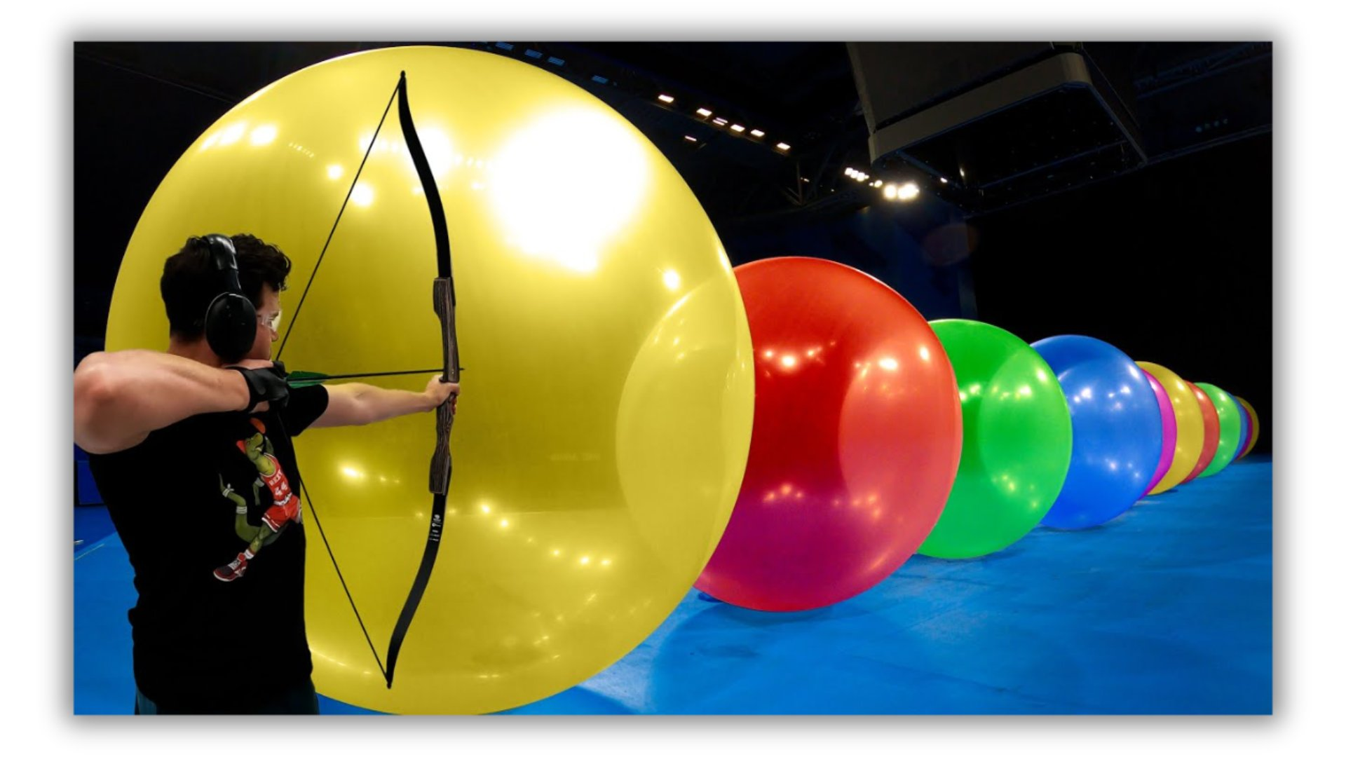 A color analysis diagram of an image depicting a person shooting an arrow at a row of large balloons. Two color palettes are shown: one representing the overall dominant colors of the image (primarily dark), and another highlighting the individual colors of the balloons (yellow, red, green, blue, etc.). Connecting lines show how the colors in the balloon image correspond to the simplified palettes.