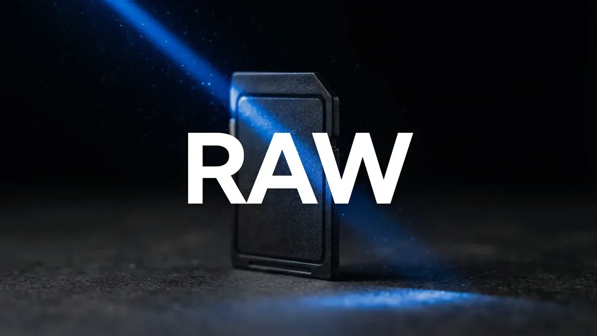 A camera memory card on a black surface lit by a single blue beam, representing the raw footage that has to be scrubbed through